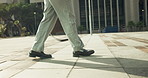 Business, person and legs walking with bag in city for work trip, commute or outdoor travel. Employee, tourist or shoes moving with luggage for career journey or job opportunity in an urban town
