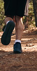 Man, fitness and running with legs in forest for outdoor workout, cardio exercise or training. Active, male person or runner sprinting with shoes or sneakers in woods for physical activity in nature