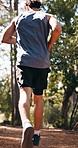 Man, fitness or running with shoes in forest for outdoor workout, cardio exercise or training. Back view, male person or active runner sprinting with sneakers in woods for physical activity in nature