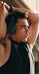 Outdoor, stretching and man with headphones for exercise, fitness and streaming podcast for wellness. Breathing, athlete and person with workout for health, online and listening to audio with tech