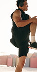 Beach, stretching and man with headphones for exercise, strength and streaming podcast for wellness. Outdoor, athlete and person with workout for health, flare and listening to audio with technology
