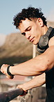 Fitness, thinking and man in city with headphones rest for workout, exercise and training outdoor. Reflection, runner and person with music, audio and radio for wellness, endurance and health in town