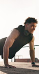 Outdoor, push up and man with exercise, training for health benefits or endurance. Person, morning routine or athlete in city, sunshine or balance with energy, cardio or workout for wellness or space