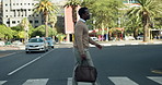 Businessman, walking or pedestrian crossing in city street for work trip, commute or outdoor travel. Man, employee or traveler on road with bag for career journey or job opportunity in an urban town