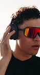 Man, fitness and listening with headphones to music for workout preparation or outdoor exercise. Active, male person or getting ready with neck warm up or sunglasses for physical activity or training