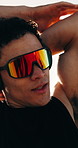Stretching, athlete and man with headphones for wellness, exercise and streaming podcast for fitness. Outdoor, runner and person with workout for health, training and listening to audio with tech