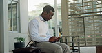 Phone, waiting and black man in city for travel, cab or taxi on mobile app for commuting to work. Technology, bag and African male employee with cellphone for car service at location in urban town.