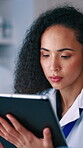 Scientist, woman and reading in lab with tablet, vaccine trial or research report for medical insight. Coworking, person and healthcare study in clinic with tech, science website or cure development.