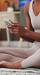 Fitness, typing and hands with phone in home, holistic health research and tutorial for yoga routine. Scroll, mindfulness guide and woman with mobile to download pilates app, exercise forum and video