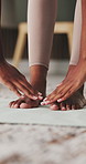 Woman, hands and stretching with feet on yoga mat in home for flexibility, workout or exercise. Active, female person or reaching toes with physical activity for fitness, health or wellness in house