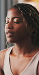 Black woman, breathe and meditation for yoga at house with chakra, inner peace and mindfulness. Female person, yogi and inhale exercise for zen, spiritual healing and self care with holistic balance