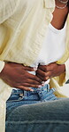 Hands, cramps and woman with stomach pain in home, menstruation and digestion problem for constipation. Discomfort, endometriosis or person with ibs condition for tummy ache, food poisoning or nausea