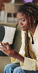 Frustrated, stress and black woman in lounge, cellphone for online announcement and bad news. Reaction, smartphone and African person in home, confused and message to contact, unhappy and 404 error