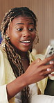 Black woman, phone and surprise online on home sofa for competition, internet and betting. Female person, technology and laughing for winning, shocked and celebration for app in living room on couch