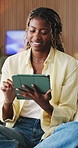 Tablet, scroll and black woman in living room with smile, social media update and online entertainment. Female person, relax and typing in house with tech, search ebook and website on weekend break.