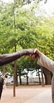 Closeup, handshake and business people in city, greeting for morning commute and funny. Woman, friends and man in street, shaking hands and laughing with happiness, travel and hello with thank you
