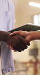 Tablet, business people and handshake in office for offer, social media marketing or sponsorship deal. Tech, team and shaking hands at work for support, advertising partnership or b2b agreement