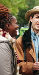 People, talking and hiking with smile outdoor for travel, discussion and trekking adventure. Happy, friends or laugh in nature for backpacking holiday, communication and gathering for weekend getaway