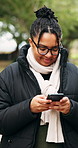 Phone, typing and woman in nature, smile and digital app for social media, internet and location. Outdoor, mobile user or person in forest, tech for communication or website info for wellness tracker