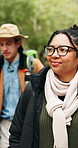 Walking, hiking and woman in nature for thinking, vacation and sightseeing on adventure with friends. Trekking, reflection or person outdoor to explore woods, smile or travel on holiday with vision