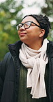 Thinking, hiking and woman in forest for travel, eco tourism and sightseeing on adventure with smile. Trekking, reflection and African person outdoor to explore nature, vacation and happy on holiday