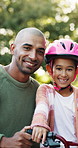 Happy dad, face or kid with bicycle for learning, safety or outdoor protection together in nature. Portrait, father and daughter with smile or helmet for cycling, parenthood or childhood in park