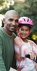 Happy dad, face or child with bicycle for learning, safety or outdoor protection together in nature. Portrait, father and daughter with smile or helmet for cycling, parenthood or childhood in park