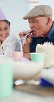 Birthday party, grandfather or children at table with horn, happiness or bonding at celebration. Fun time, grandparent or kids at house with decoration, family connection or social gathering at event