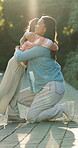 Outdoor, mother and girl with hug for support, happiness and family connection for weekend bonding. Smile, woman and child with embrace for security, trust and comfort for healthy relationship