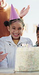 Family, singing and child with cake at birthday party for celebration, special day and wish outdoor. Happy, parents and girl with applause, hat and candles for event, gathering and song for milestone