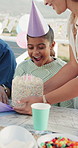 Mother, surprise and child with cake at party outdoor for birthday, celebration and gathering. Shocked, kid and wow expression for dessert, milestone congratulations and special occasion with family