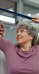 Physiotherapist, stretch or old woman in clinic with resistance band, mobility or support in rehabilitation. Wellness, patient or chiropractor with aid, arm exercise or muscle recovery in retirement.