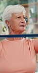 Physiotherapy, stretch or old woman in clinic with resistance band, mobility or support in rehabilitation. Wellness, patient or chiropractor with aid, arm exercise or muscle recovery in retirement.