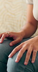 Nervous, hands and woman on sofa in home with anxiety, mental health or stress in living room. Frustration, overthinking and female person with worry for decision, choice or trauma in apartment.
