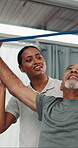 Physiotherapist, stretch or old man in clinic with resistance band, mobility or support in rehabilitation. Wellness, patient or chiropractor with aid, arm exercise or muscle recovery in retirement.
