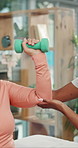 Senior, woman or weightlifting with physiotherapist or dumbbells for muscle rehabilitation in clinic. Elderly, female person or patient with caregiver or weight for arm strength, exercise or recovery