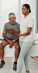 Senior, man and physiotherapist in clinic with clipboard, discussion and update for rehabilitation. Elderly person, healthcare worker and talk with checklist, physical therapy plan or medical report.