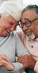 Happy, bonding and elderly couple relax in home for love, marriage and connection together. Smile, care and senior man with woman in retirement on sofa for commitment and hug in living room of house