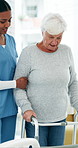 Old woman, walker and physiotherapy with support, balance and talk with recovery in retirement. Senior person with disability, rehabilitation or guide for mobility, walking frame or help at clinic