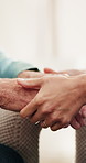 Holding hands, support and person with senior man on sofa in home for comfort, compassion or empathy. Security, sympathy and family in living room with connection, bonding or care in apartment.