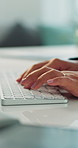 Hands, keyboard and typing with employee at desk in office for planning, report or research. Computer, fingers and review with business person in workplace for administration, agenda or schedule