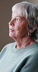 Thinking, window and senior woman in house with nostalgia, memory or reflection on weekend. Decision, relax and elderly female person in retirement with planning, choice or ideas in living room.