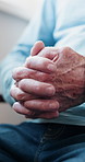 Anxiety, hands and senior man on sofa in home with nervous, stress or mental health in living room. Retirement, comfort and elderly male person with depression, worry or regret in house with emotion.