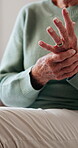 Arthritis, hands or old woman in house with massage, joint pain or stiffness in finger movement. Retirement, ache or elderly person in home with rub, inflammation and muscle stretching for tendinitis
