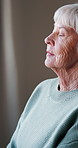 Thinking, window and senior woman in home with nostalgia, memory or reflection in living room. Decision, planning and elderly female person in retirement with choice, ideas or remember in house.