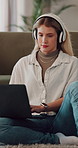 Student, headphones and woman with laptop in lounge, typing and listening to music with subscription. Studying, online and happy person with tech for assignment, education and streaming audio in home
