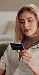 Woman, home and banking with credit card for online shopping, payment or wireless transaction. Female person, shopper or user with debit on sofa for ecommerce app, order or virtual purchase in house