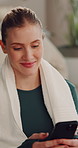 Phone, break and woman in home for exercise with reading fitness blog for tips or advice on app. Happy, technology and female person with cellphone for relax with online workout in living room.