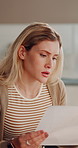 Woman, stress and headache with documents for debt, mortgage expenses or tax inflation in home. Frustrated, female person or migraine with concern, papers or invoices for financial crisis or bills