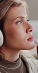 Headphones, thinking and woman in home, relax and listening to music, sound and podcast. Happy, rest and person in living room, streaming for audio and song with weekend break or reflection in Canada